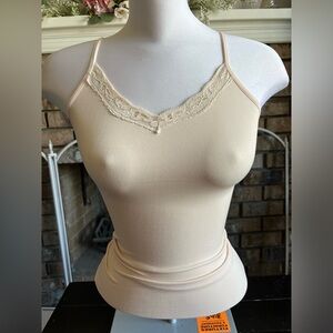 Tight fitting light pink tank top.